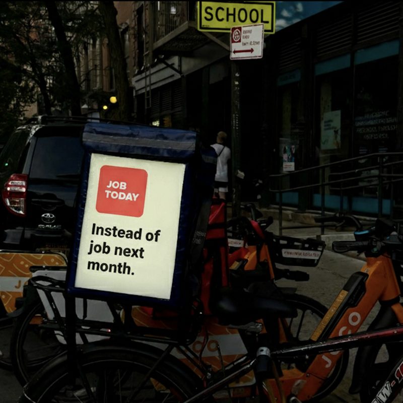 Delivery bikes parked on a city block with MetroMesh display bags